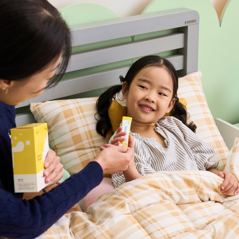 엄마가 아이에게 영양제를 주는 모습